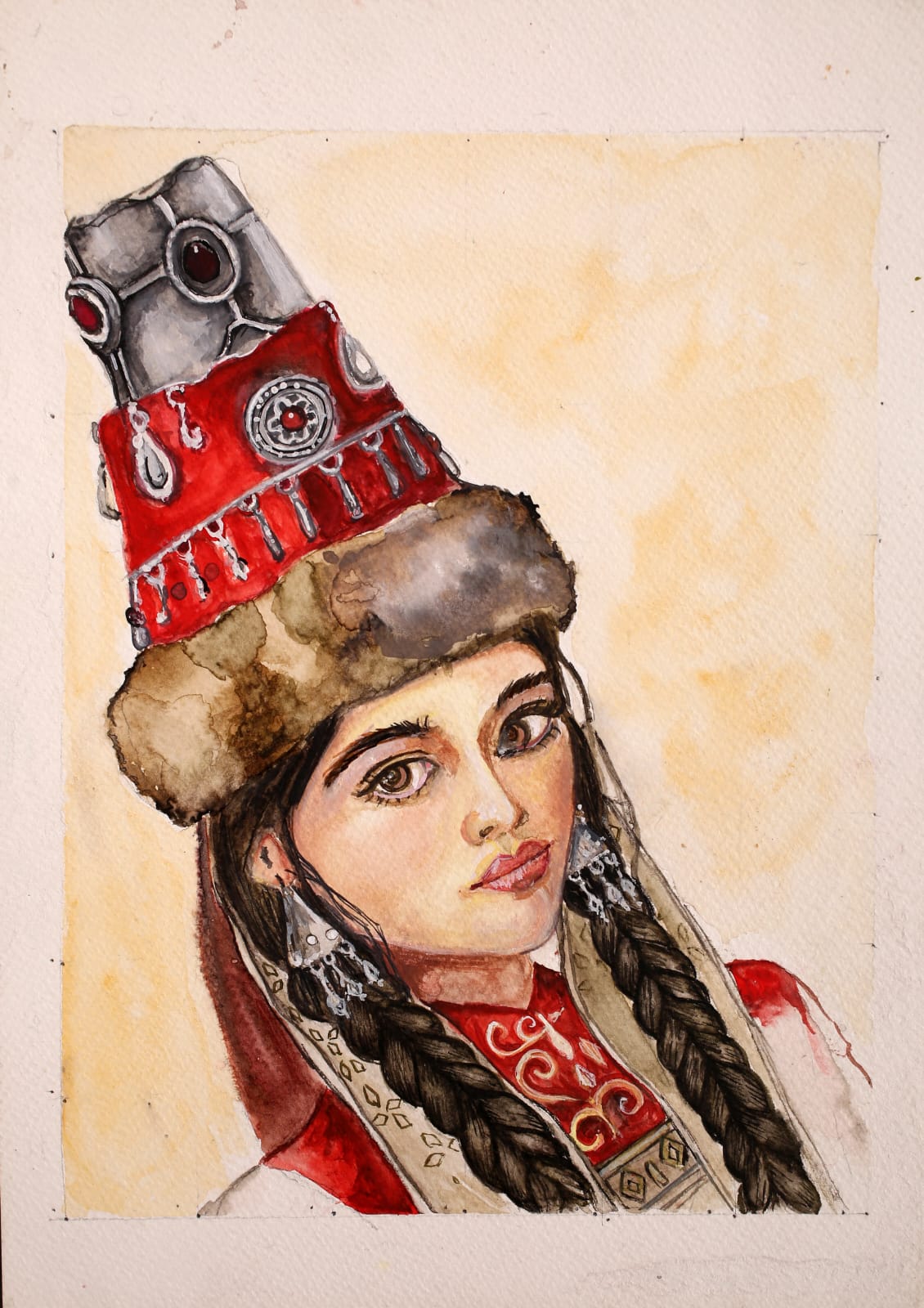 A young woman in a tall red and silver bridal headdress with fur trim, long braids and silver earrings.