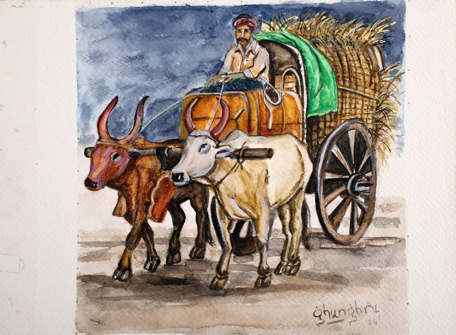 A farmer driving a bullock cart loaded with hay, pulled by one brown and one white bullock under a blue evening sky.