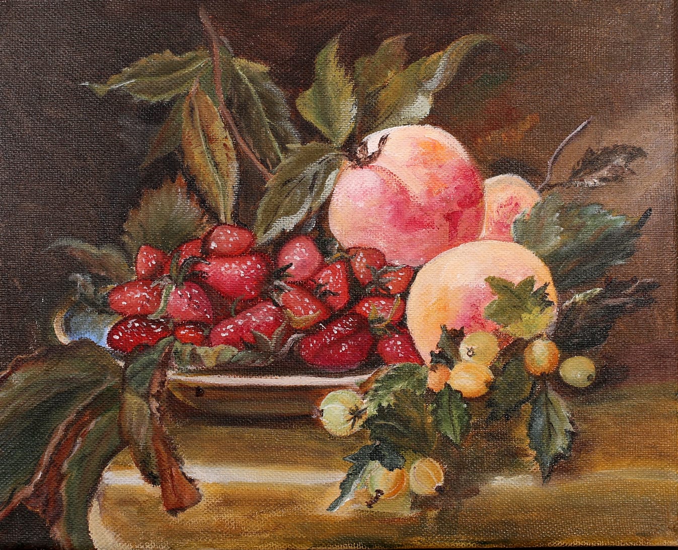 A still life of strawberries in a dish, with peaches, gooseberries and leaves on a wooden table.