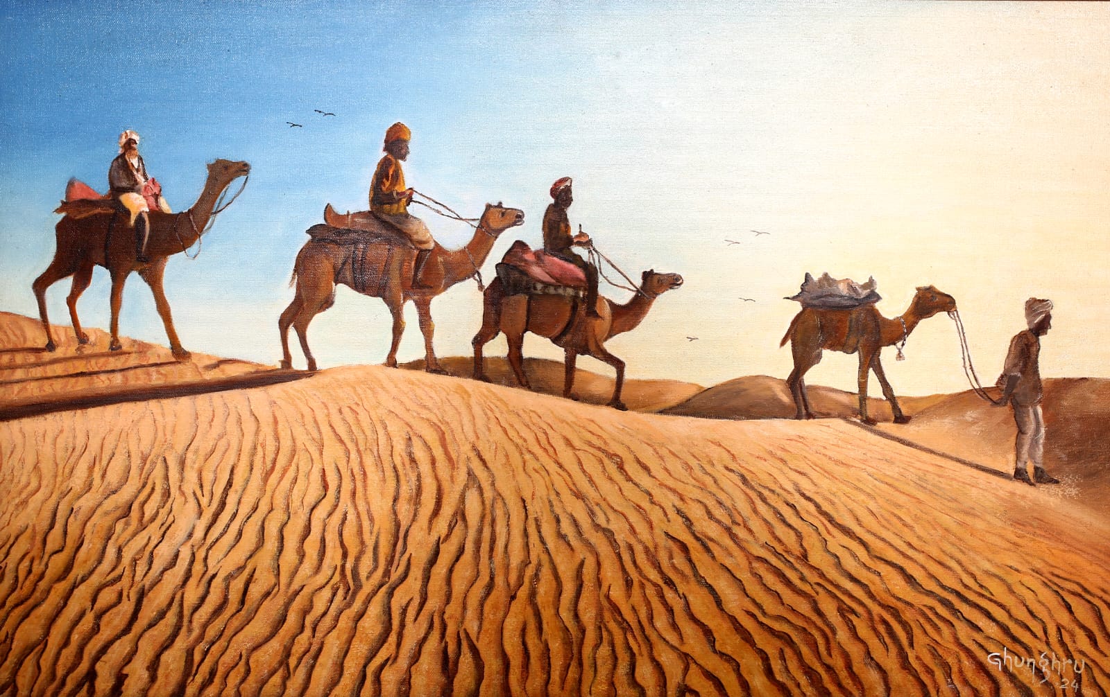 A camel caravan with turbaned riders cresting a rippled sand dune under a clear blue sky.